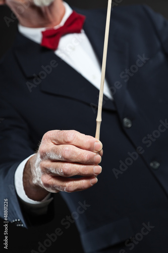 Photo: Conductor conducting an orchestra isolated. Conductor conducting an orchestra isolated.