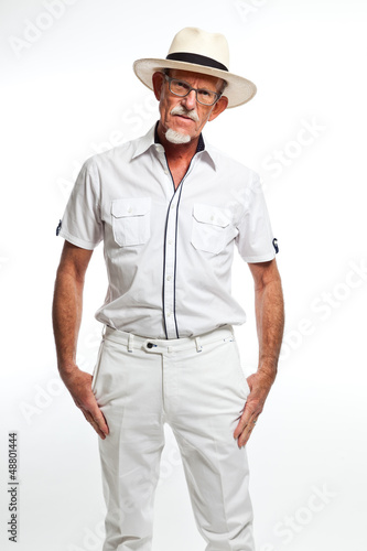 Photo: Well summer dressed senior man with hat. Isolated. Well summer dressed senior man with hat. Isolated.