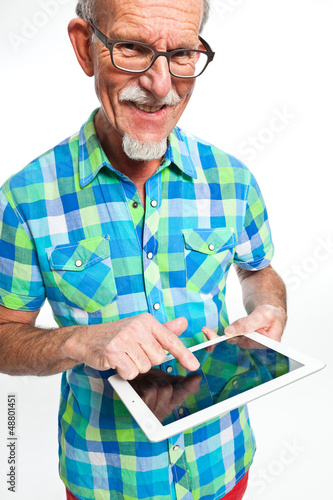 Photo: Well dressed senior man with tablet computer. Isolated. Well dressed senior man with tablet computer. Isolated.