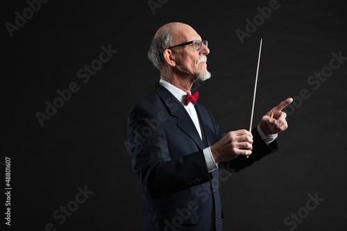 Photo: Senior conductor wearing suit. Studio shot. Senior conductor wearing suit. Studio shot.