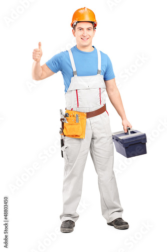 Photo: Manual worker holding a tool box and giving a thumb up Manual worker holding a tool box and giving a thumb up