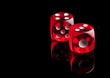 Photo: Two red dice on black background Two red dice on black background