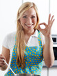 Beautiful young woman tasting her self prepared meal