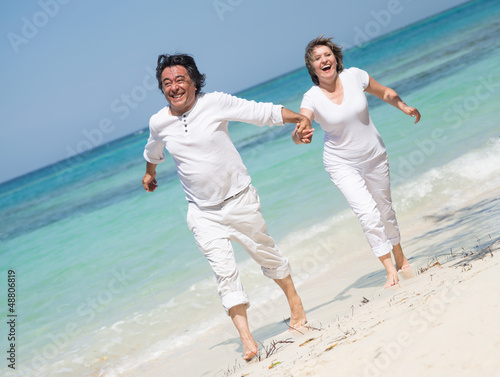 Photo: Beautiful couple at the beach Beautiful couple at the beach