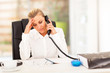 serious middle aged businesswoman talking on phone