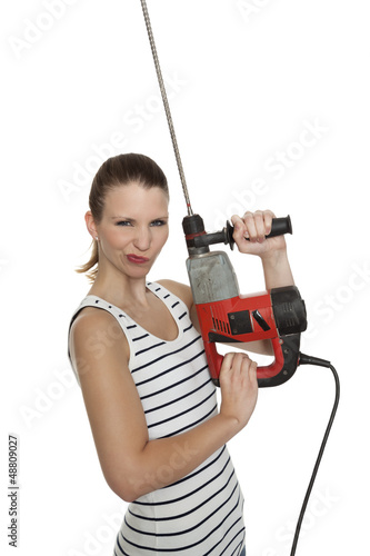 Photo: Young craftswoman with a power drill Young craftswoman with a power drill