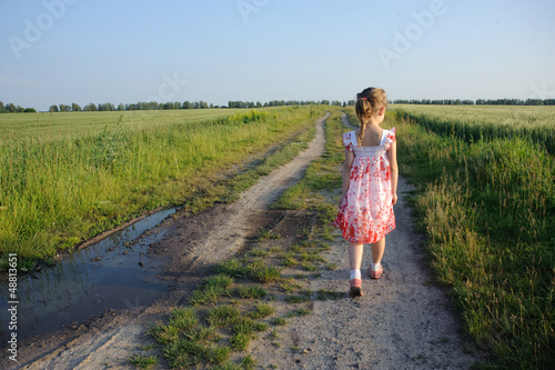Photo: little girl walking on the road little girl walking on the road