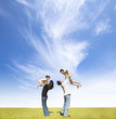 Photo: happy family on the grass with cloud background happy family on the grass with cloud background