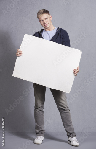 Photo: Friendly man showing white blank panel. Friendly man showing white blank panel.