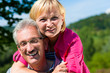 happy mature or senior couple having walk