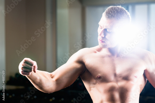 Photo: Bodybuilder posing in Gym Bodybuilder posing in Gym