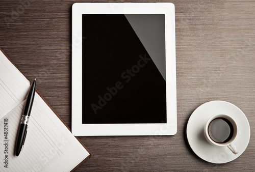 Photo: empty tablet and a coffee on the desk empty tablet and a coffee on the desk