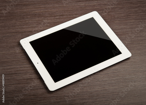 Photo: white blank tablet pc on a desk white blank tablet pc on a desk