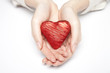 Female hands holding a red heart
