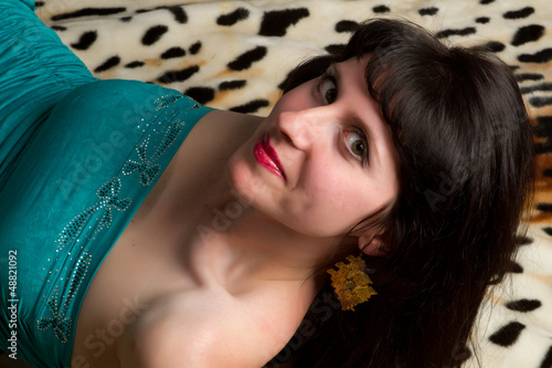 Photo: young brunette on a tiger background young brunette on a tiger background