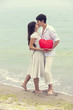 Closeup portrait of happy couple at the beach with heart.