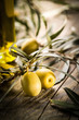 Organic olives with bottle of oil on a wooden table.