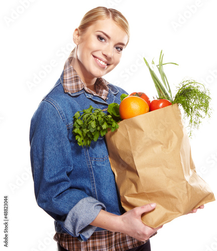 Photo: woman holding a bag full of healthy food. shopping . woman holding a bag full of healthy food. shopping .