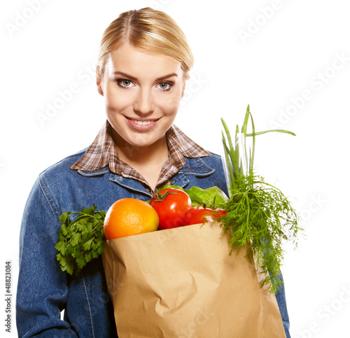 Photo: woman holding a bag full of healthy food. shopping . woman holding a bag full of healthy food. shopping .
