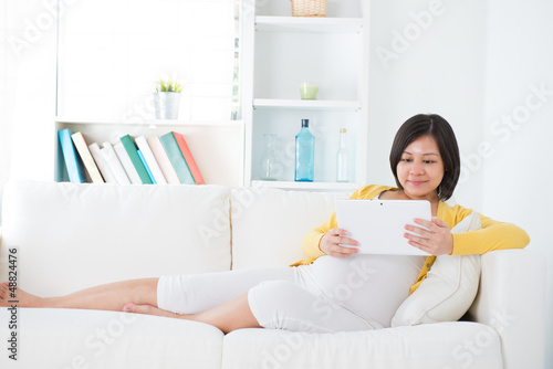 Photo: Asian pregnant woman using tablet computer Asian pregnant woman using tablet computer