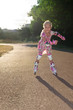 Little girl with rollers outdoors