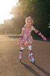 Little girl with rollers outdoors