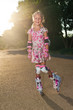 Little girl with rollers outdoors