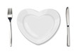 Photo: plate in shape of heart, table knife and fork isolated on white plate in shape of heart, table knife and fork isolated on white
