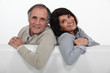 Adult couple stood with blank advertising panel