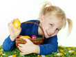 Cute blonde child is happy to find her Easter eggs