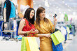 Two girlfriends with shopping bags