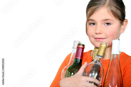 Photo: Little girl carrying glass bottles Little girl carrying glass bottles