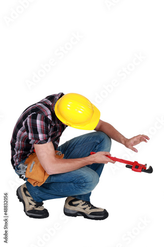 Photo: Plumber working on invisible pipe Plumber working on invisible pipe