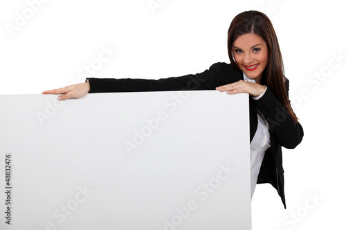 Photo: Attractive business woman with blank poster Attractive business woman with blank poster