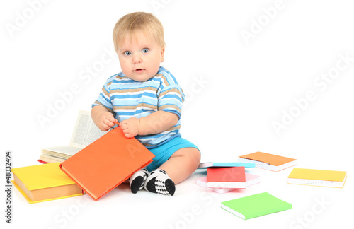 Photo: Little boy with multicolor books, isolated on white Little boy with multicolor books, isolated on white