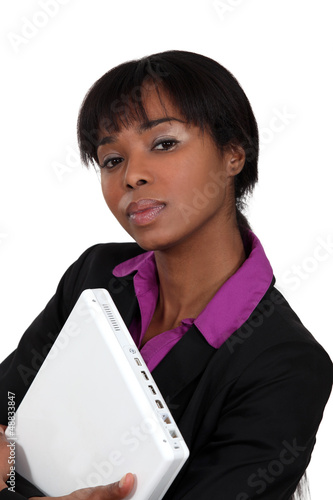 Photo: Woman with computer in the arms Woman with computer in the arms