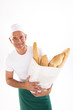 Baker holding bag of bread