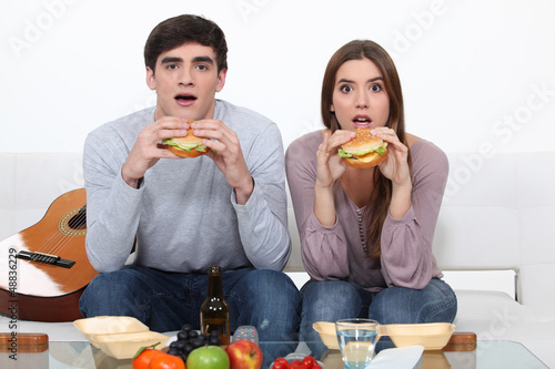 Photo: Two students eating burgers Two students eating burgers