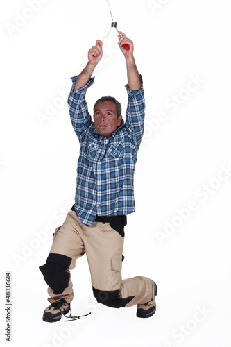 Photo: electrician fixing the installation and having an accident electrician fixing the installation and having an accident