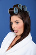 Woman with curlers sticking out his tongue