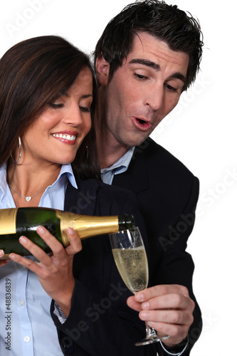 Photo: happy couple drinking champagne happy couple drinking champagne