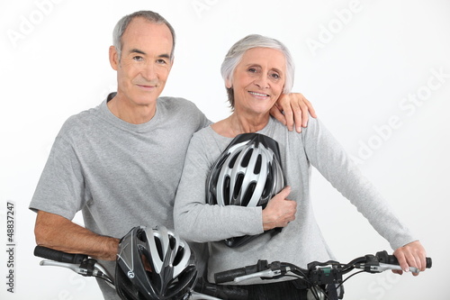 Photo: Elderly couple riding bikes Elderly couple riding bikes