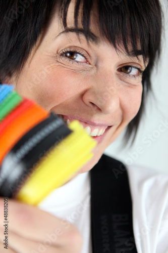 Photo: Woman holding colorful cable ties Woman holding colorful cable ties
