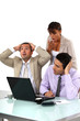 Three shocked business people looking at results