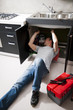 Plumber working on kitchen sink