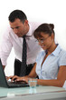Man supervising his assistant's work
