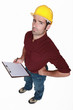 Distrustful tradesman with a clipboard