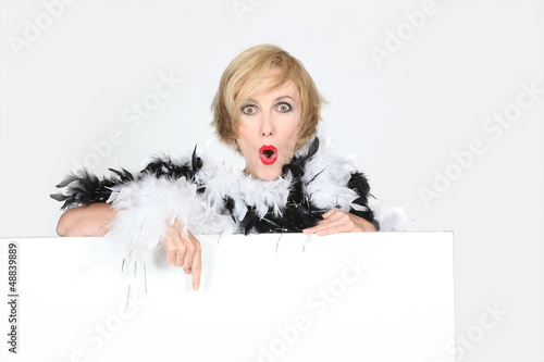 Photo: Fashionable woman pointing to a blank sign Fashionable woman pointing to a blank sign
