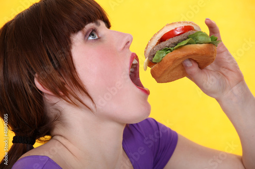 Photo: teenager eating hamburger teenager eating hamburger