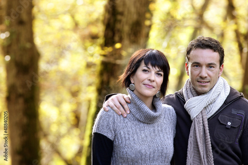 Photo: Couple strolling in the park together Couple strolling in the park together